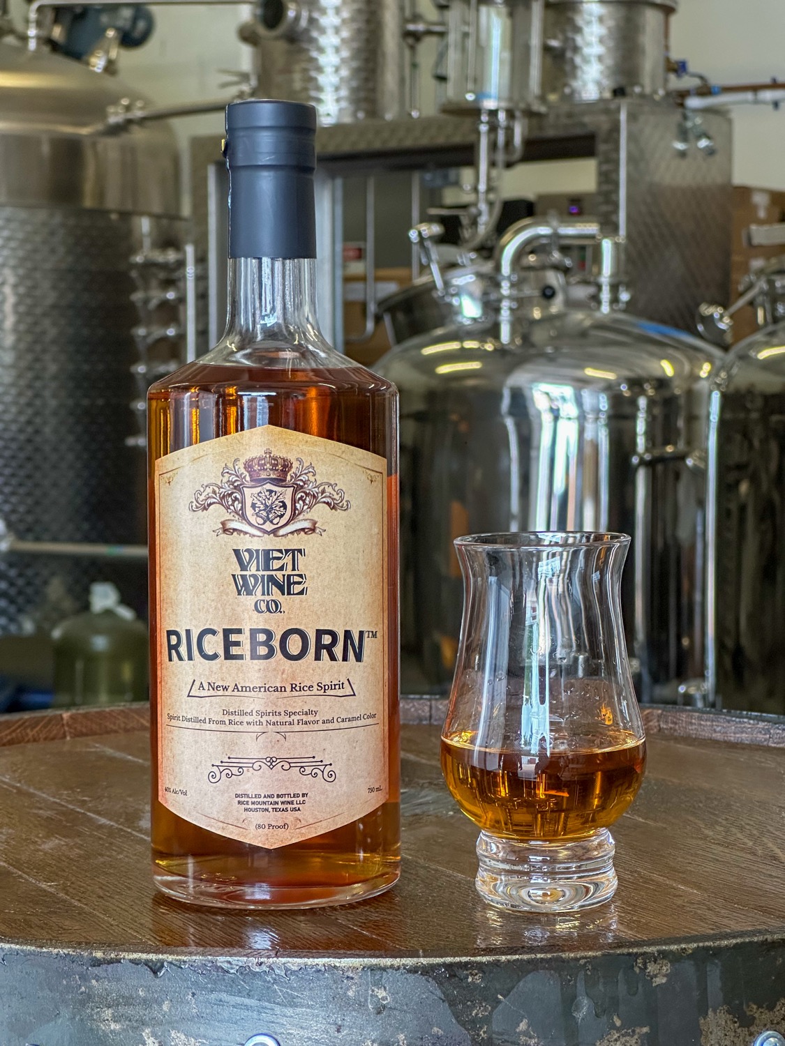 Viet Wine Co. RiceBorn bottle on a barrel at the distillery